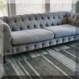 F15. Gray canvas fabric tufted sofa. 30”h x 93”w x 36”d 